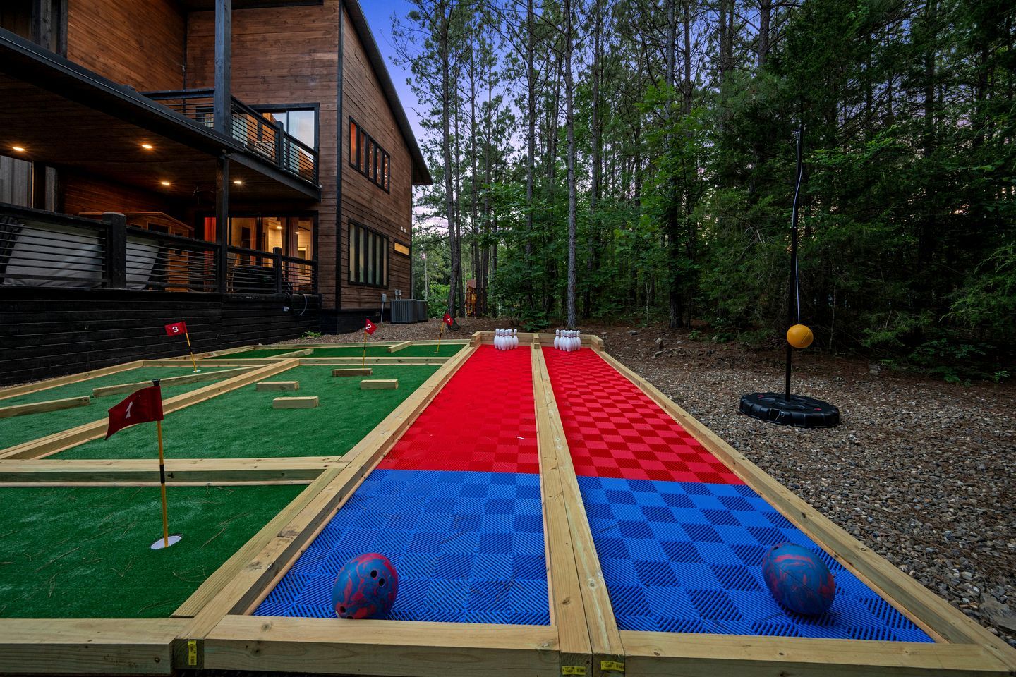 Un terrain de croquet avec un bâtiment en bois en arrière-plan.