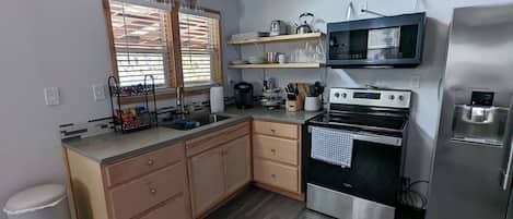 Coffee/tea maker, fridge, microwave, oven