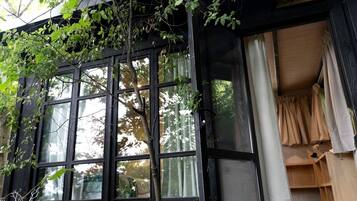 A building with large windows, a tree in front, and a sign that reads 'SPACE'.