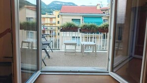 A balcony with a view of buildings and mountains. - Hostdomus - Myros Apartment (Finale Ligure)