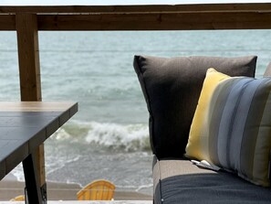 A wooden deck with a view of the ocean.