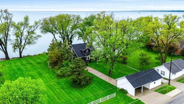 Ein Wohngebiet mit einem Haus, einem kleinen Gartenhaus und einem umzäunten Hof.