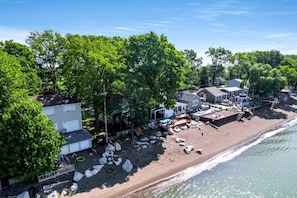 A coastal residential area with houses, a beach, and a pool.