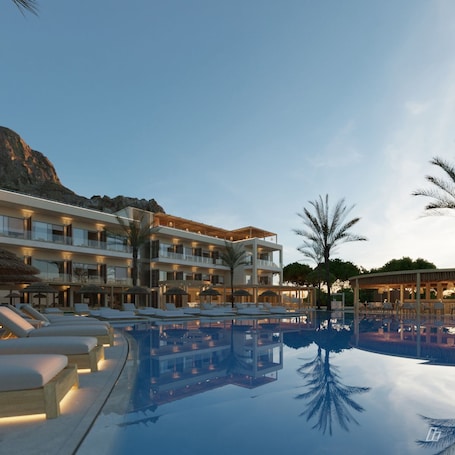 Seasonal outdoor pool, open 9:00 AM to 5:00 PM, pool umbrellas. Pefkian Ethos Hotel & Suites
