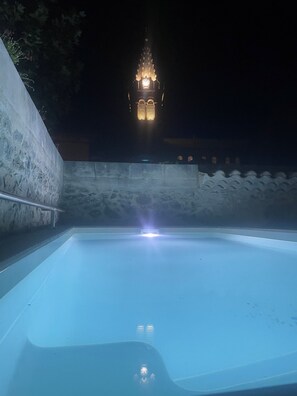 A swimming pool at night with a distant illuminated tower. - Stone house with swimming pool - Gorges de l'Ardèche (Saint-Remèze)