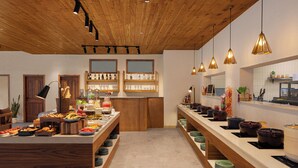 A buffet setup with various food items and beverages, wooden ceiling, and pendant lighting. - Samsara Hill Resort By Leisure Hotels (Mussoorie,)