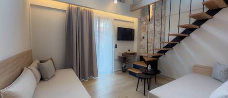Deluxe Room - Split Level with Mountain View & Sea View | Living area | 43-inch Smart TV with digital channels