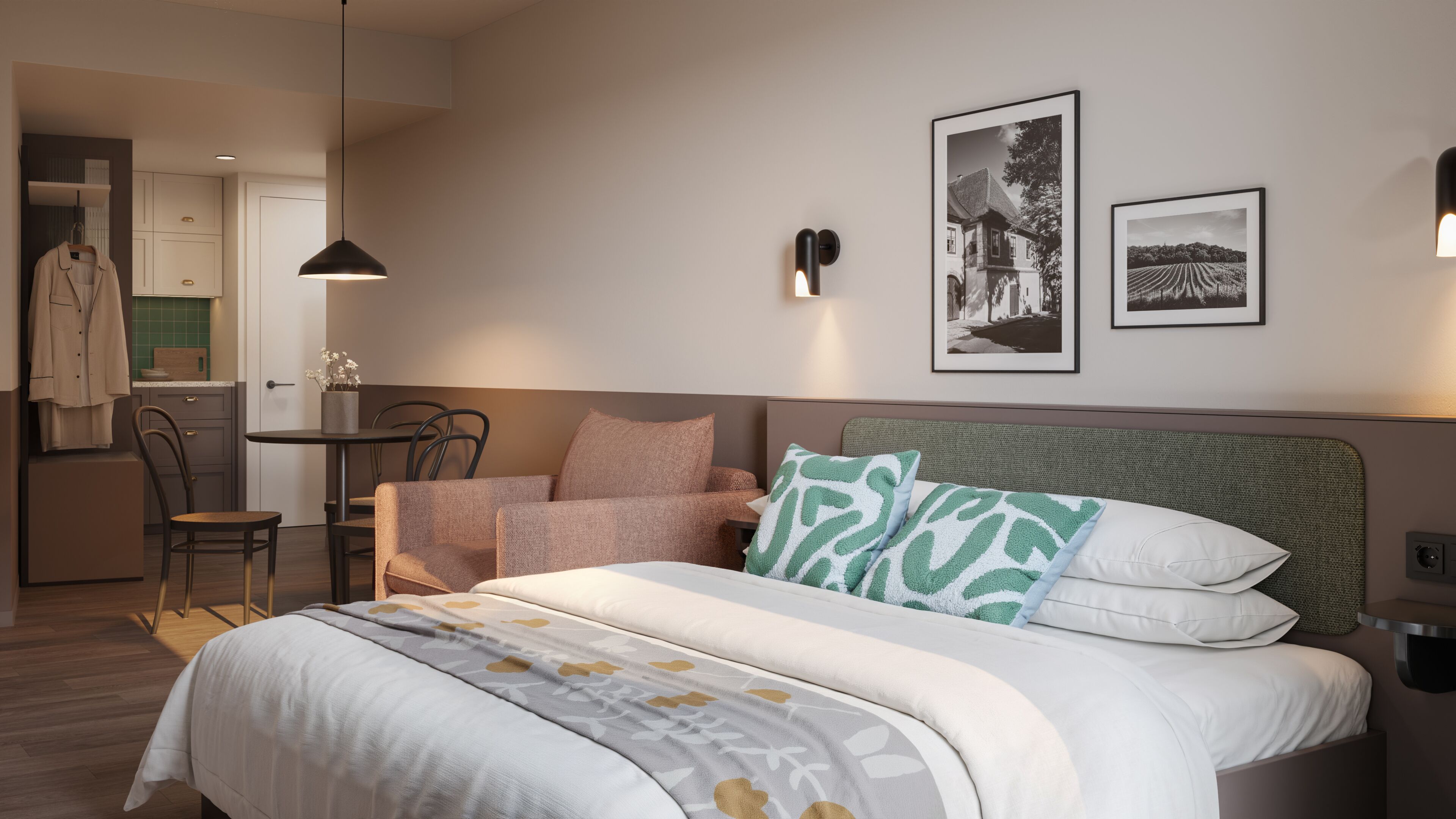 A bedroom with a bed, a chair, a table, and a kitchenette.