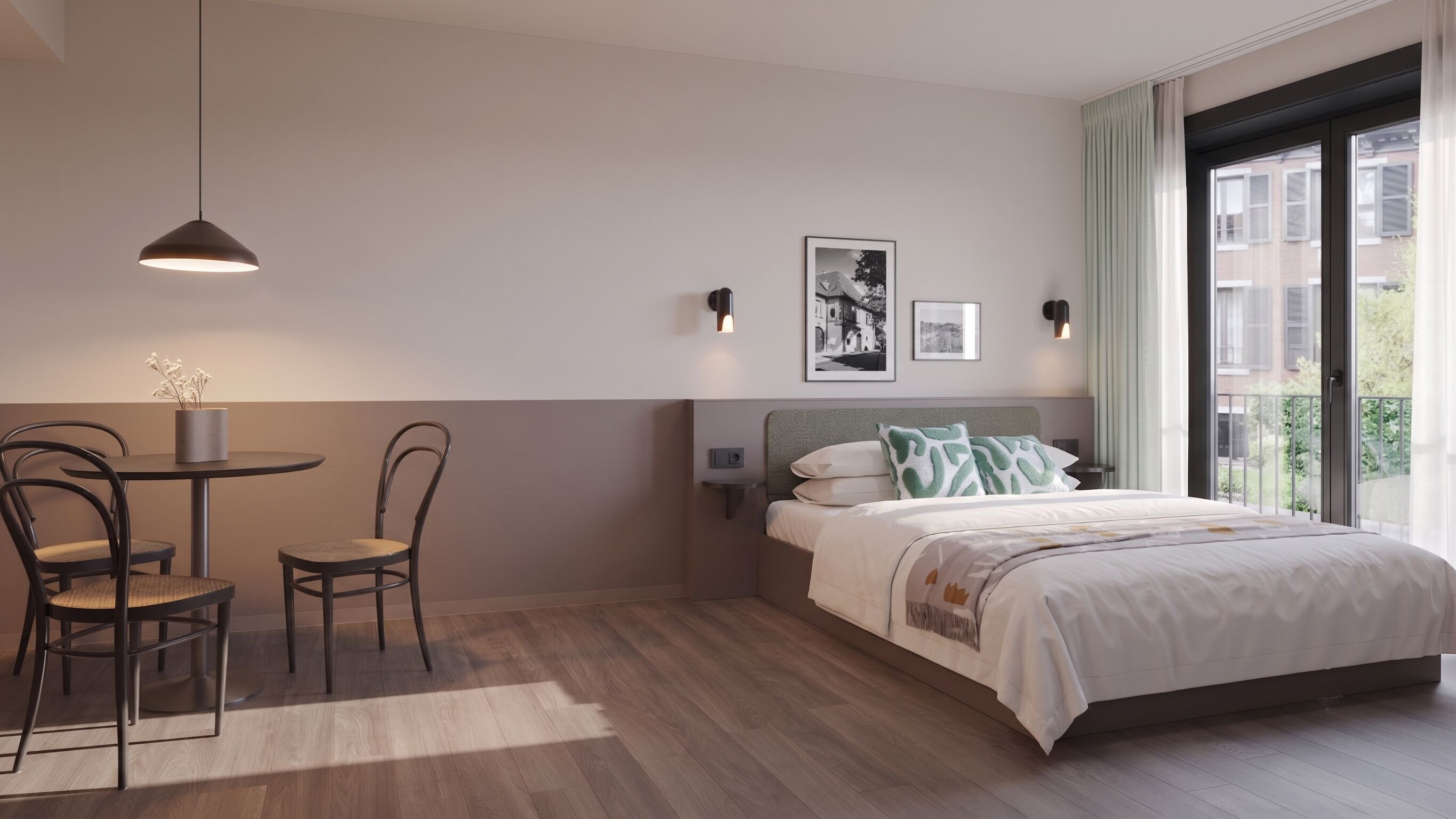 A hotel room with a bed, a table with chairs, a pendant light, and two wall-mounted lights.