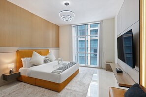 A modern hotel room with a large bed, a flat-screen TV, a large window, and a ceiling light fixture. - Premium Stay in Duja Tower | Close to DIFC & Downtown (Dubai)
