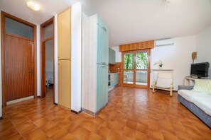 Ein geräumiger Wohnbereich mit Küche, Essbereich und einer Couch.