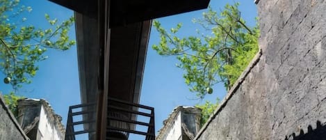 A stone structure with a metal railing and a staircase leading up to a platform.