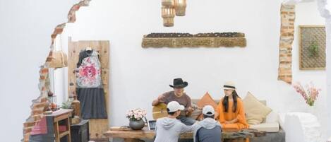 A room with a rustic archway, a wooden table, and a sofa.