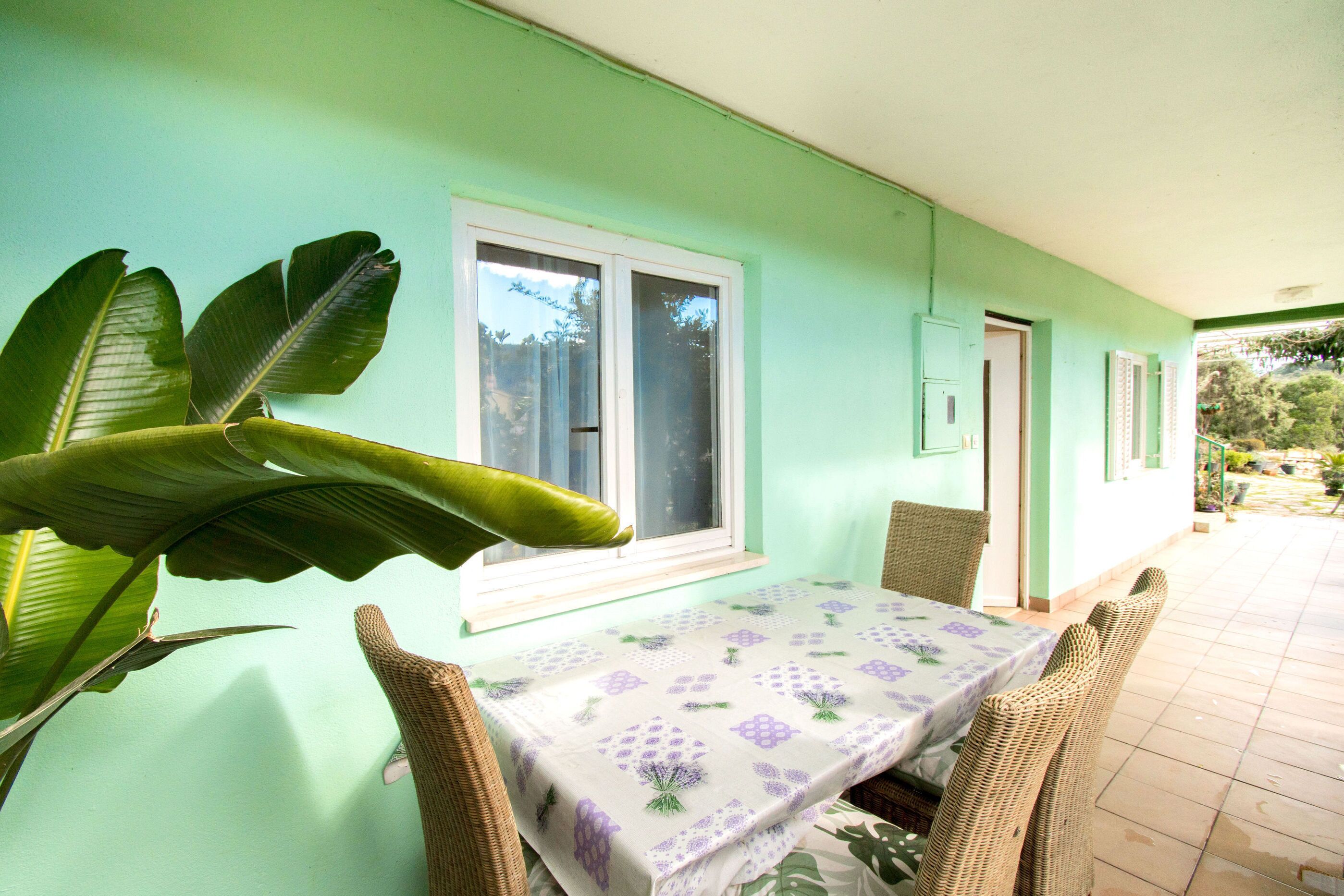 A room with a table and chairs, a window, and a door.