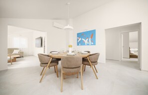 A modern dining area with a round table, chairs, and a pendant light. - Apartments Bianca Vodice (Vodice)