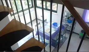 A high-rise interior with a dining area, a coffee machine, and a view of the outside. - Apartment Adri (Rovinj)