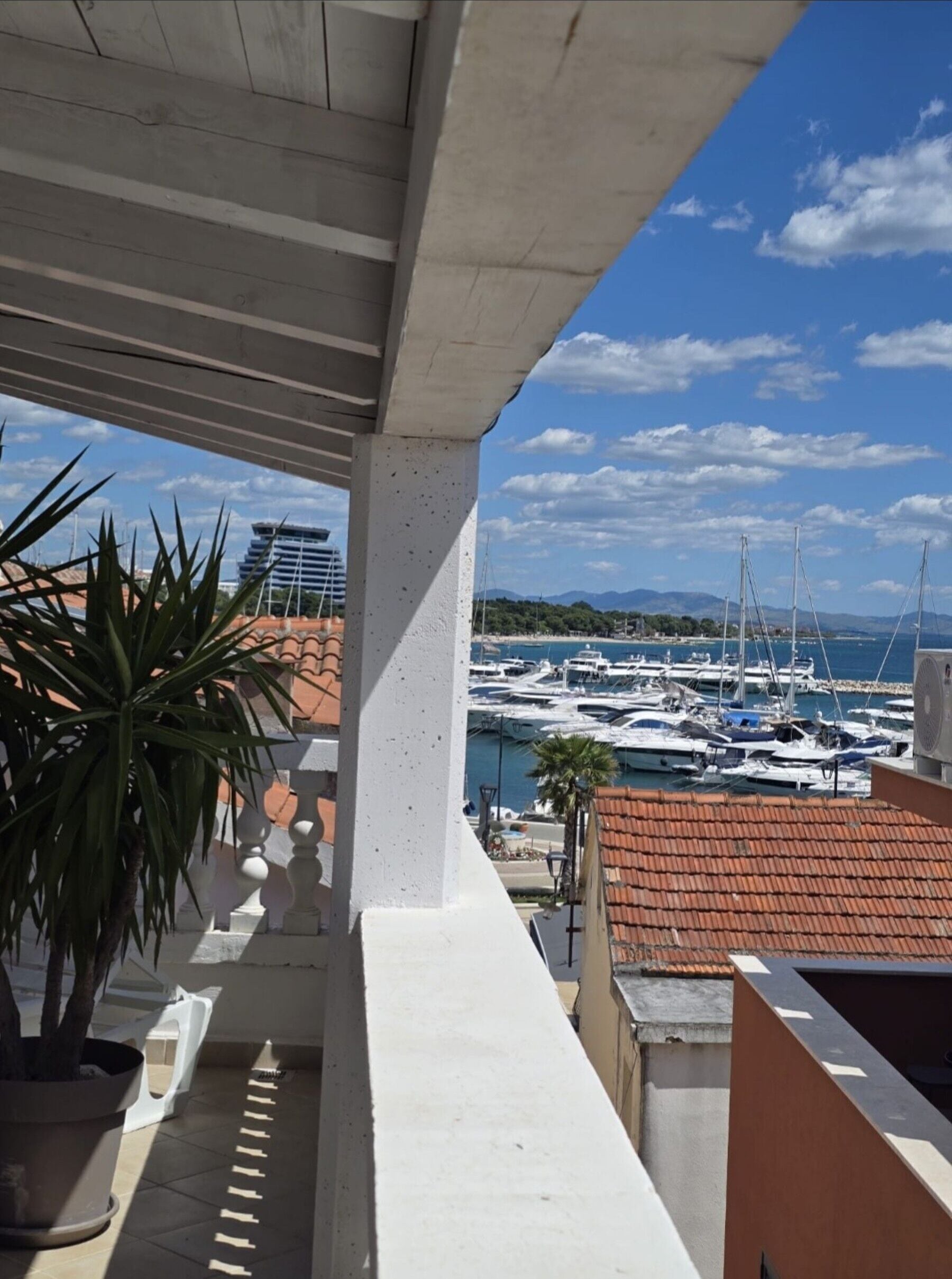 A balcony with a view of a marina and boats.