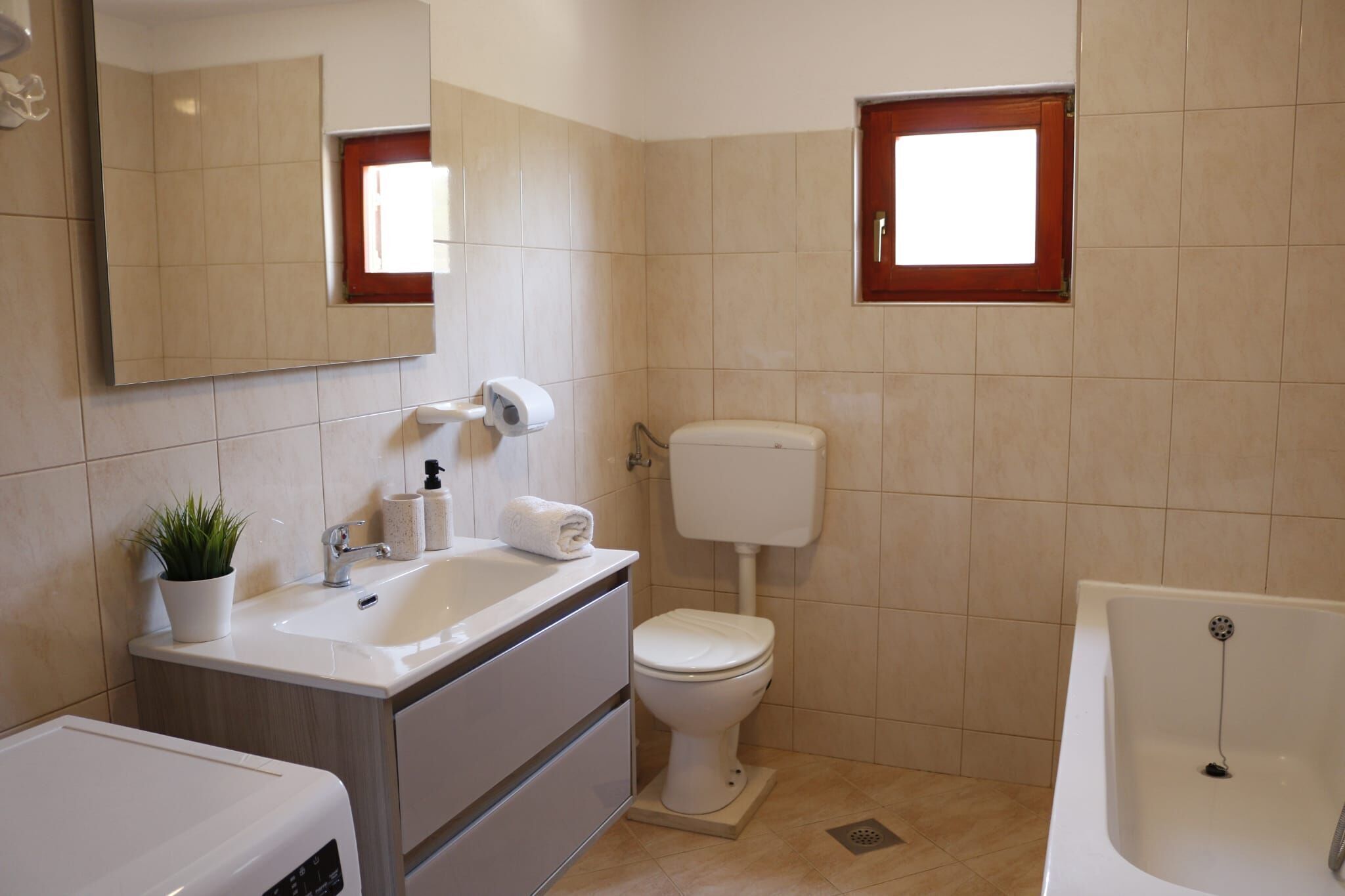 A bathroom with a sink, toilet, and bathtub.