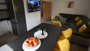 A modern living space with a kitchen, dining area, and a sofa. - House Ivana (Pula)