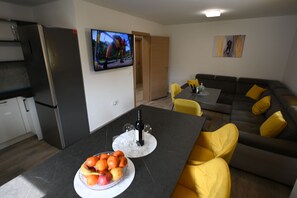 A modern living space with a kitchen, dining area, and a sofa. - House Ivana (Pula)