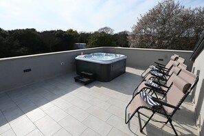 A rooftop terrace with a hot tub, outdoor seating, and a view of trees. - House Ivana (Pula)