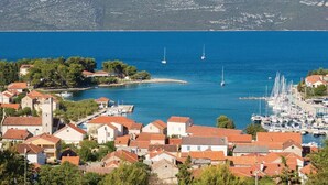 A coastal town with buildings, a marina, and boats. - House Veli Iz Oldtown (Zadar)