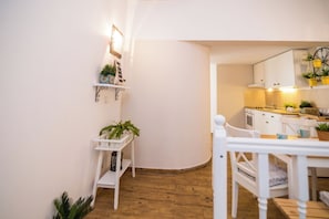 A modern kitchen with white cabinets, a wooden countertop, and a built-in oven. - Apartments Tellus (Biograd na Moru)