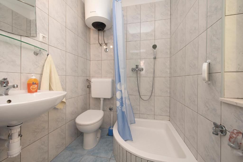 A bathroom with a sink, toilet, shower, and bathtub.