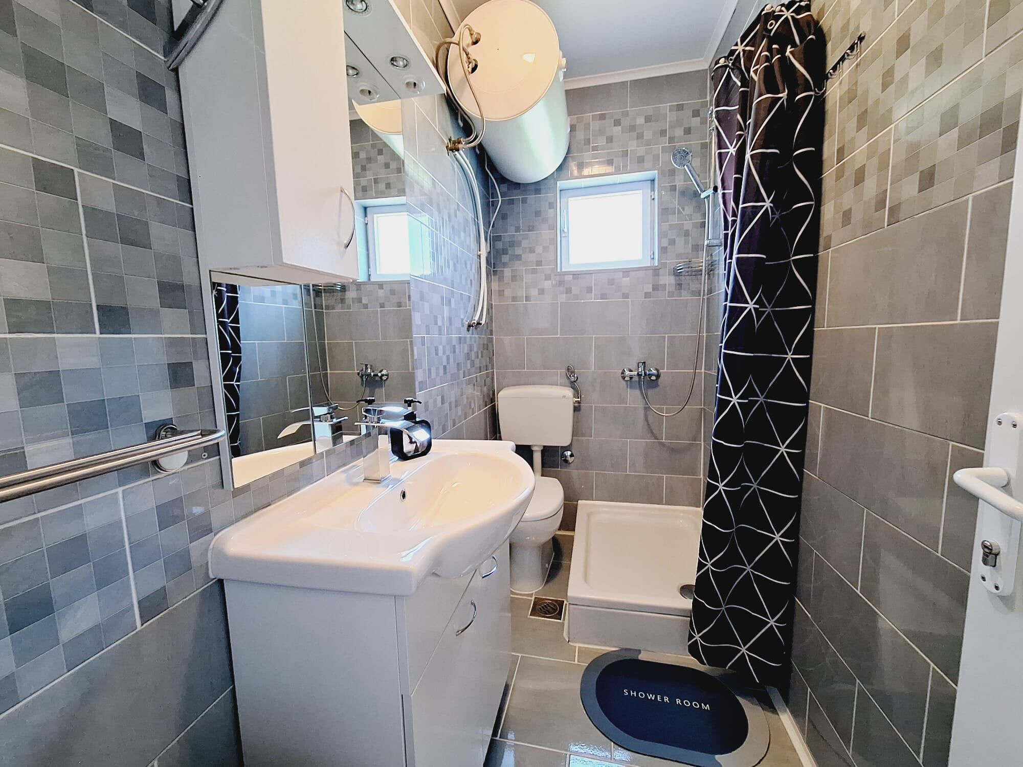 A bathroom with a toilet, sink, shower, and a bathtub.
