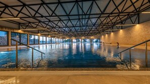 An indoor swimming pool with a high ceiling and large windows. - Mobile Home Oaza Mira Camping 920 (Pakostane)