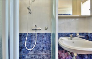 A bathroom with a shower, a sink, and a mirror. - Apartments Durdica (Umag)