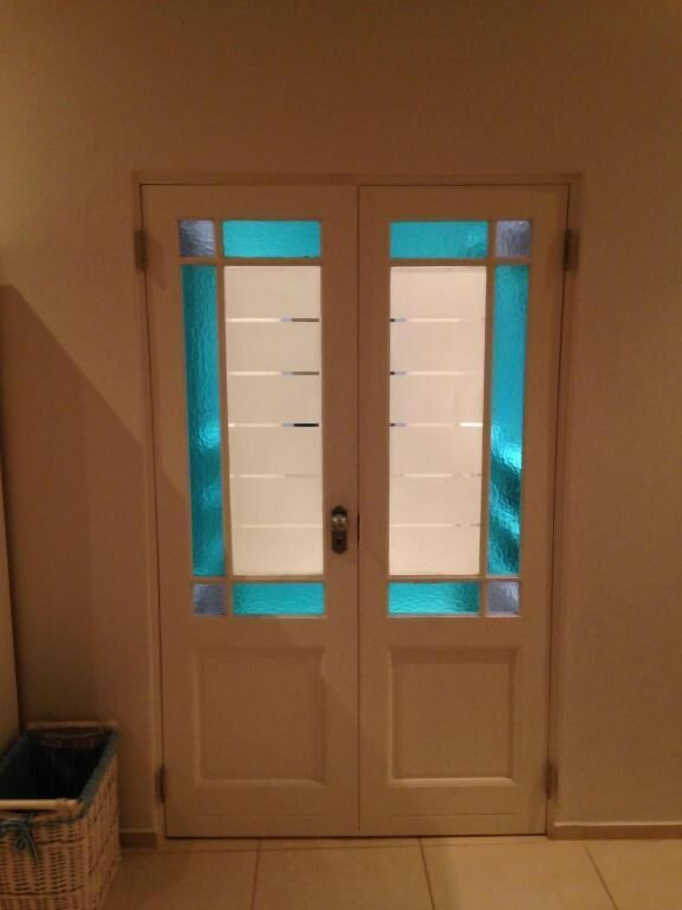 A double door with frosted glass panels and a metal handle.