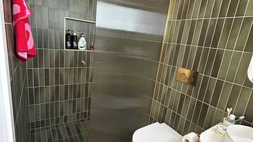 Shower, towels, soap, toilet paper