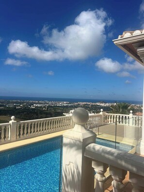 A pool with a clear view of a cityscape and ocean in the background. - Villa Sleeps 4 With Indoor Pool (Denia)