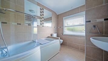 Combined shower/bathtub, deep-soaking bathtub, towels