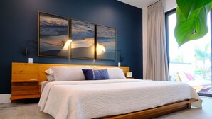 A bedroom with a wooden bed, two wall-mounted lamps, and a large window with a view. - Luxury Naples Private Retreat w/Resort Pool + Gym (Naples)