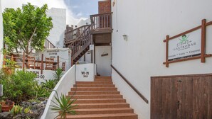 A staircase leading to a bar area with a sign indicating Wi-Fi availability. - Apartment in a Natural Park on Fuerteventura’s West Coast (Valle de Santa Inés)