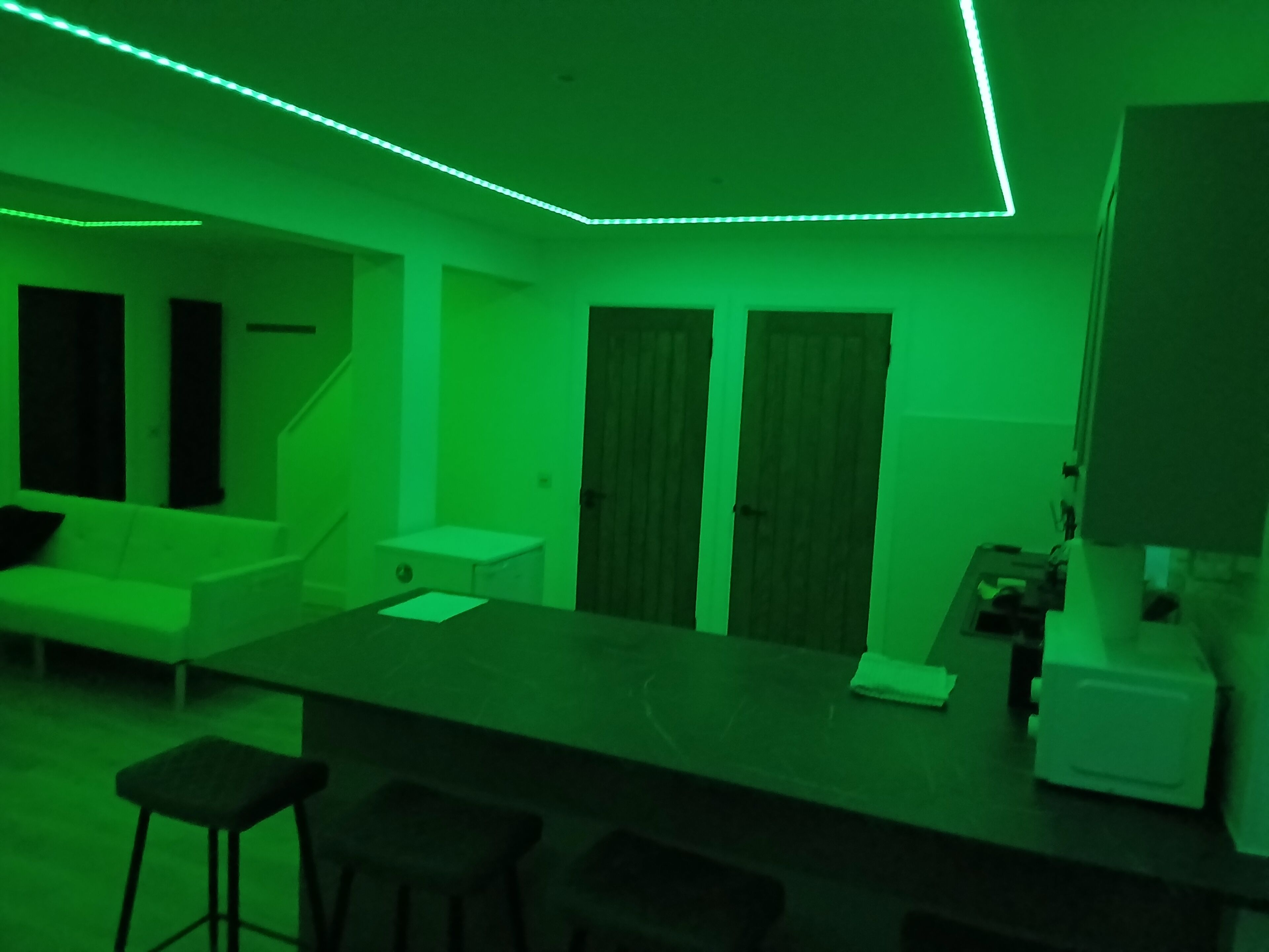 Een kamer met een bar, een bank en een kleine tafel.