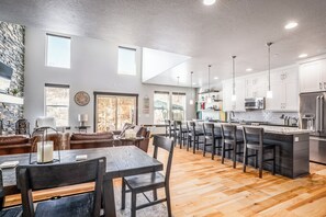 A spacious kitchen with a central island, modern appliances, and ample natural light. - Charming 5BR mountain retreat in Deer Valley, Park City, perfect for 14 guests. (Hideout)