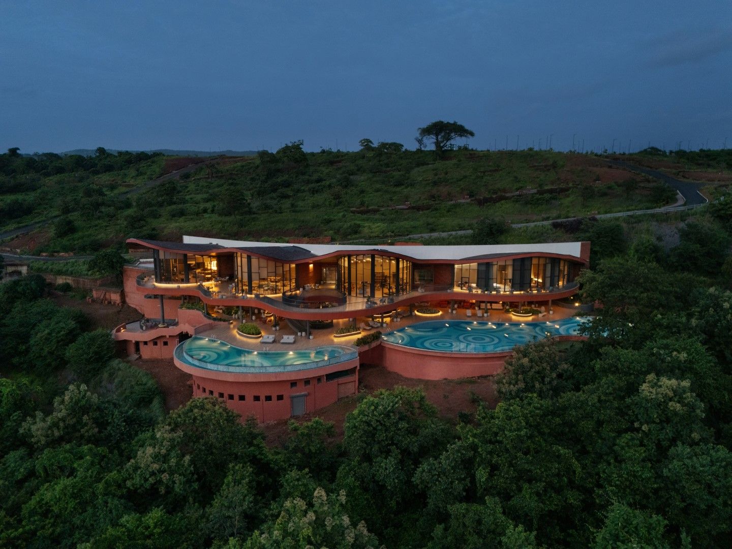 A modern resort with multiple swimming pools and a large outdoor area.