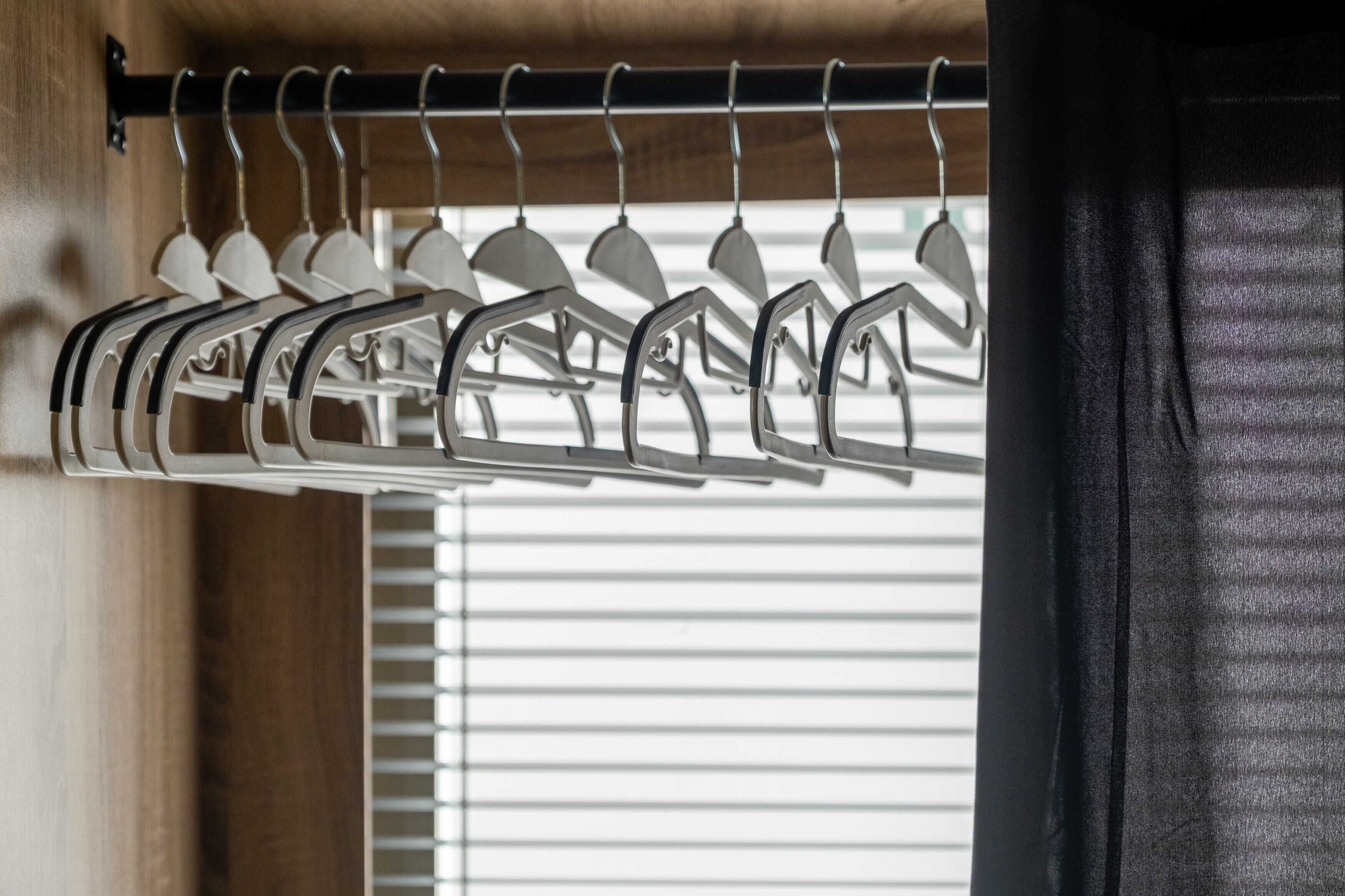 A metal coat rack with multiple hangers.