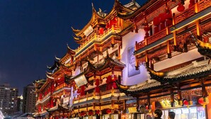 A traditional multi-story building with ornate architecture, including curved roofs and intricate wooden details. - Shanghai Rongju Hotel (Shanghai)