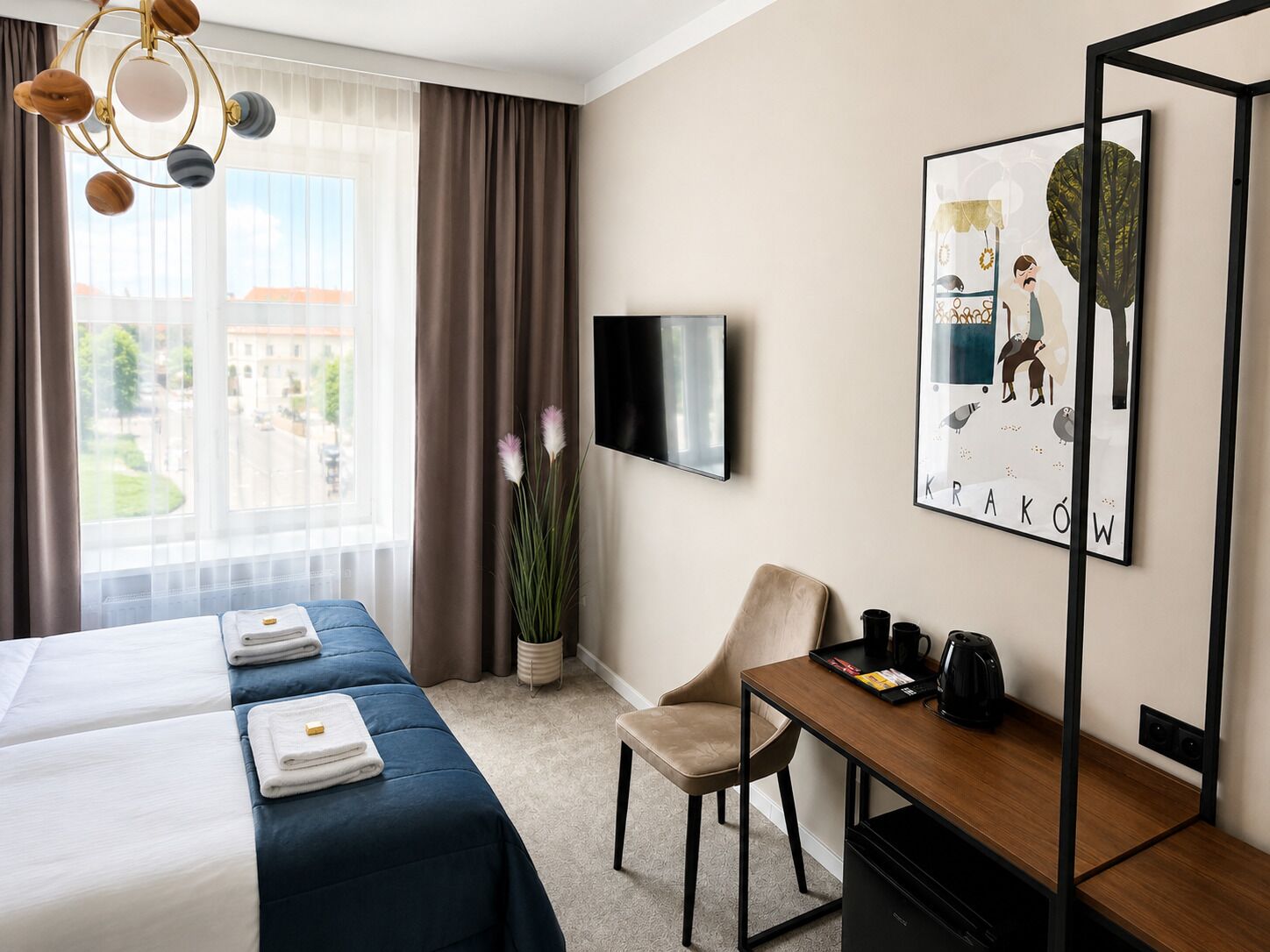 A hotel room with a bed, a desk, a chair, a TV, and a window with curtains.