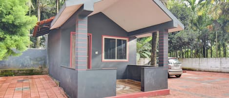 A small, single-story building with a flat roof, a window, and a door.