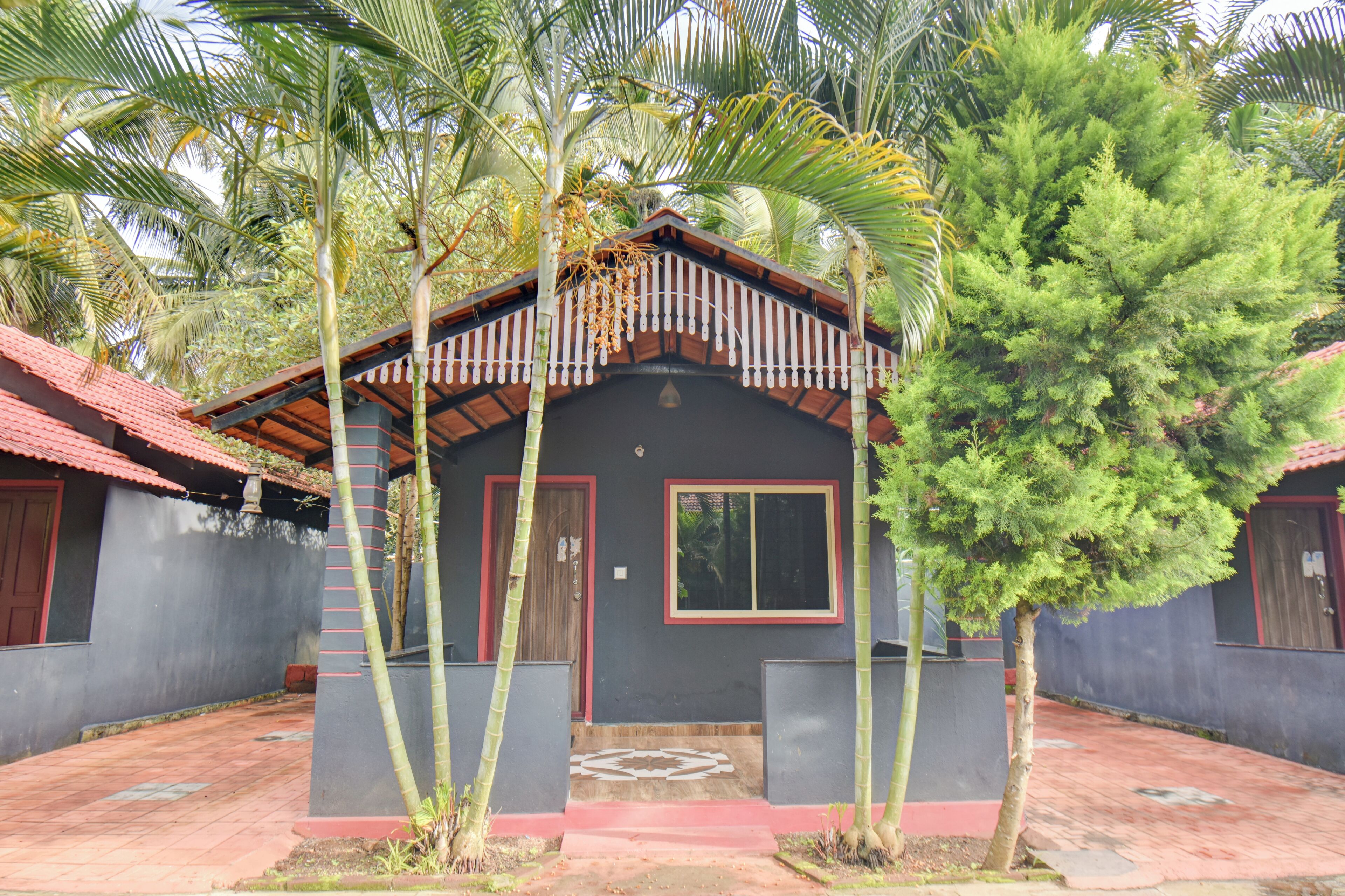 A building with a red roof, a central door, and a window.
