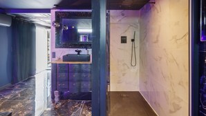 A modern bathroom with a marble wall, a sink with a mirror, and a shower area. - Bed and Breakfast 'Luxurious Love Room By Vill'amore' with Private Terrace, Wi-Fi and Air Conditioning (Solaro)