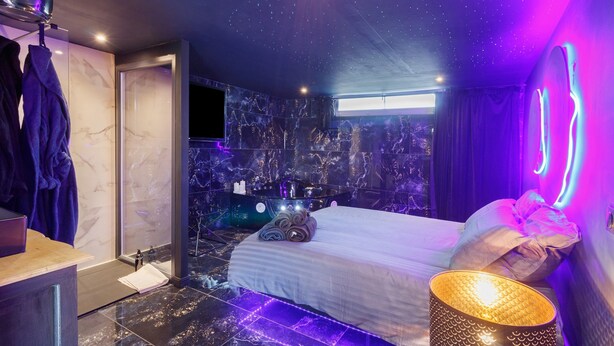 A modern hotel room with a bed, a vanity, a shower, and a view of the city. - Bed and Breakfast 'Luxurious Love Room By Vill'amore' with Private Terrace, Wi-Fi and Air Conditioning (Solaro)