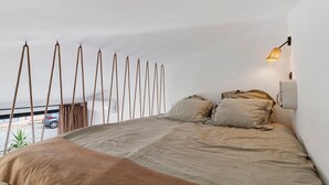 A bedroom with a bed, a hanging light fixture, and a view of the outside. - Bed and Breakfast 'Vill'amore' with Sea View, Wi-Fi and Air Conditioning (Solaro)