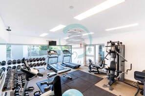 A gym with treadmills, dumbbells, and weight machines. - Coastal Magnificence Pool Workspace Parking (Darwin)