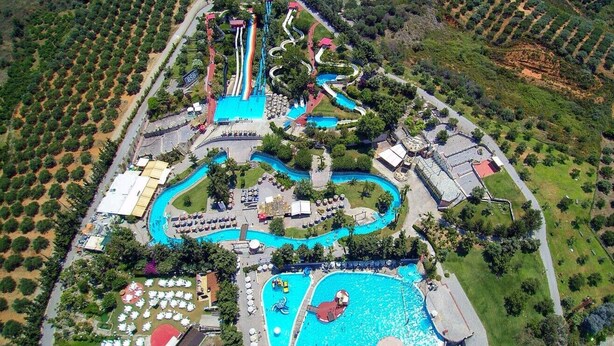 An aerial view of a theme park with a large water park, multiple slides, and pools. - Villa w/Heated Pool, 5 min walk to Beach and Shops (Georgioupoli)